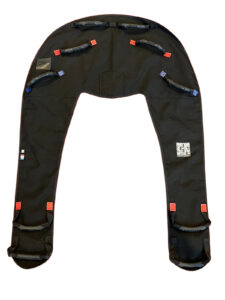 Black parachute/harness with leg loops and multiple red pull tabs, used to secure a skydiving or paragliding system